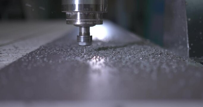 Shavings fly from the cutter, close-up. Factory milling installation, cnc.