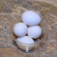 white chicken eggs in a transparent box - delicious and healthy food ingredients, located on a...