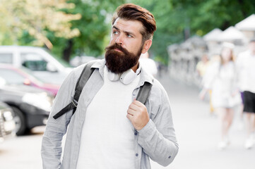 Discover local showplace. Backpack for urban traveling. Hipster backpack urban street background. Tourism and backpacking. Vacation concept. Modern rest. Bearded man travel. Guy exploring city