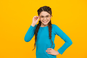 think without my glasses. little beauty wear glasses. happy childhood. small girl has smile. kid hairstyle fashion. smiling child with long hairdo. cheerful teen has bad sight. Hair braided in braids