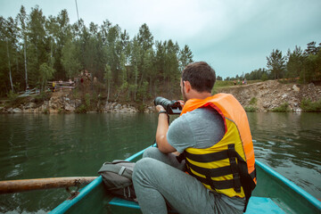 Photographer captures the best postcards of the forest on a canoe. Tourism and camping concept