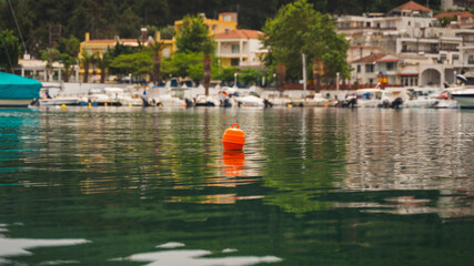 floating orange buoy in the sea port