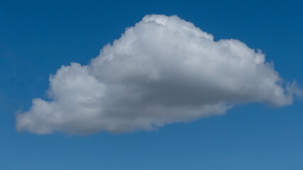 single fluffy cloud on blue sky