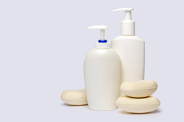 Obraz na płótnie Canvas piece of soap and bottle of liquid soap over light grey backgound with clipping path