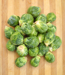 freshly brussel sprouts and some whole ones in wooden board