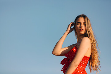 Young blonde model poses outdoors