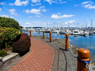 Tranquil walkway around marina with moored yachts in Sidney on Vancouver Island, British Columbia, Canada