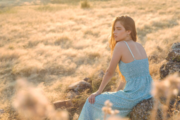 Beautiful blond girl at sunset in countryside