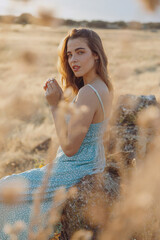 Beautiful blond girl at sunset in countryside