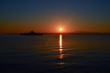 Canakkale with a sunrise and a steamer, morning hours, red colors, sunrise, orange, red, yellow colors
