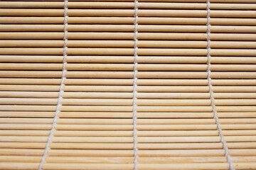 Photo of a sushi mat in the form of a bamboo background.