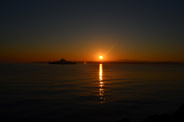 Canakkale with a sunrise and a steamer, morning hours, red colors, sunrise, orange, red, yellow colors
