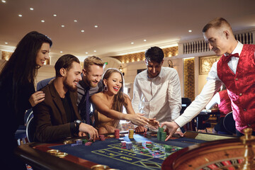 A happy woman takes a win at the roulette poker casino