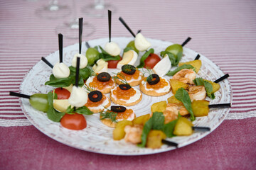 Buffet table with snacks, canape and appetizers at luxury wedding reception outdoors, copy space. Serving food at event. Catering banquet table