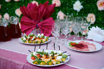 Buffet table with snacks, canape and appetizers at luxury wedding reception outdoors, copy space. Serving food at event. Catering banquet table