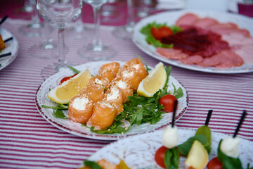 Buffet table with snacks, canape and appetizers at luxury wedding reception outdoors, copy space. Serving food at event. Catering banquet table
