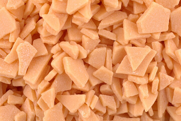 Orange candy chocolate background, copy space. Abstract candy texture. Top view, flat lay