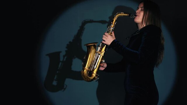 Woman Plays on Saxophone. Musical Concept