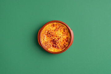 French creme brulee with burnt sugar in clay tray. Fine custard dessert