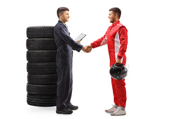 Auto mechanic shaking hands with a professional racer