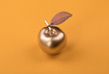 golden metal apple isolated on yellow background