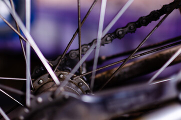 Fototapeta na wymiar Close up of bicycle chain with a purple background