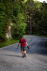Nature photographer explores a mountain road.