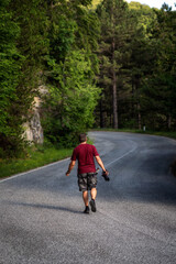 Fototapeta premium Nature photographer explores a mountain road.