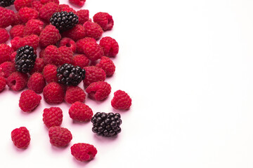 Raspberries and blackberries on light