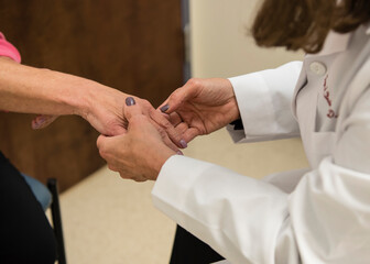 Dermatologist examining patient's skin