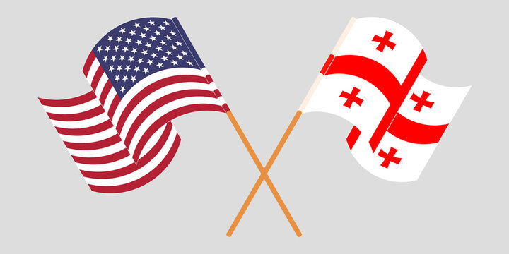 Crossed and waving flags of Georgia and the USA