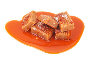 Delicious candies with caramel sauce and salt on a white background