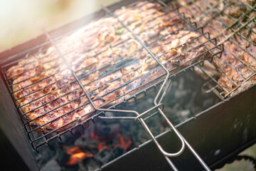 fried pieces of meat on the grill, blurred image