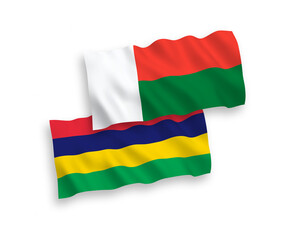 Obraz premium National vector fabric wave flags of Mauritius and Madagascar isolated on white background. 1 to 2 proportion.