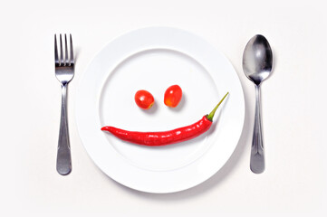 Red chili smile, close up white plate/ isolate background 