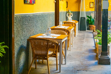 Small spanish patio with family restaurant. Cozy chairs and small tables in Garachico, Tenerife, Spain