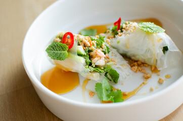 Spring rolls served with shrimp on a white plate. Cooking. National cuisine