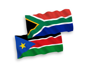 Obraz premium National vector fabric wave flags of Republic of South Sudan and Republic of South Africa isolated on white background. 1 to 2 proportion.