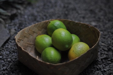 stack of fresh lemons in a wicker basket