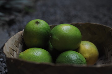 stack of fresh lemons in a wicker basket