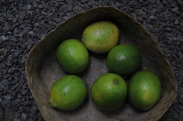 stack of fresh lemons in a wicker basket