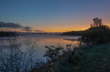 Colourful sunrise on Ottawa River with fog on water nobody