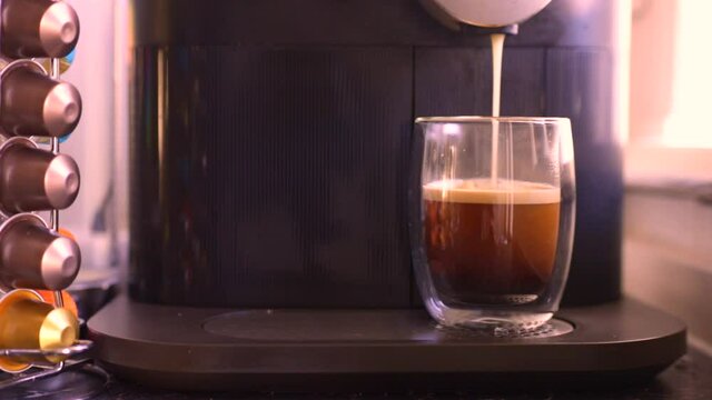 Espresso coffee being made with a nespresso machine