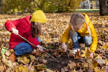 Children hiking in the forest. Two girls exploring nature in the woods on warm autumn day. Outdoor recreation and awesome adventures with children in fall