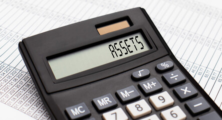 A calculator with the word ASSETS on the display