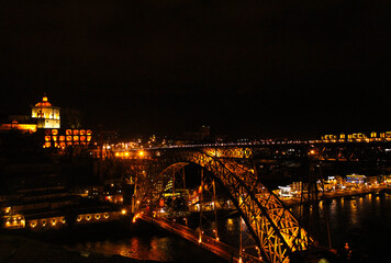 Fototapeta na wymiar View of the D.Luis Bridge in Porto, lit up at night.