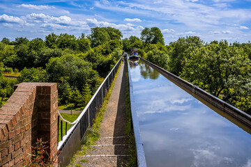Fototapeta na wymiar A view looking towards a canal boat on the Edstone Aqueduct, Warwickshire, the longest aqueduct in England