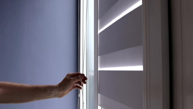 Man installing cassette roller blinds on windows