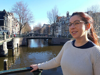 Fototapeta na wymiar woman traveling between the canals of Amsterdam on the Dutch waters