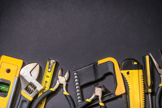 Tools for master builder prepared before work on black background with place for advertising